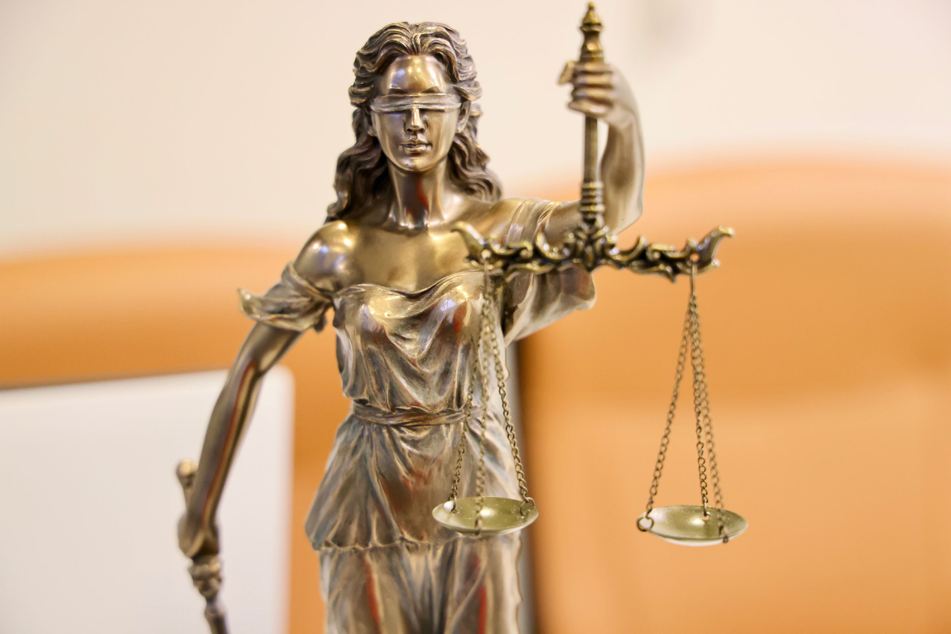 Bronze statue of Lady Justice holding scales and a sword